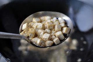 Mapo Tofu with Peanuts step 9: Heat oil until it reaches seven parts hot, then add the tofu cubes and stir-fry